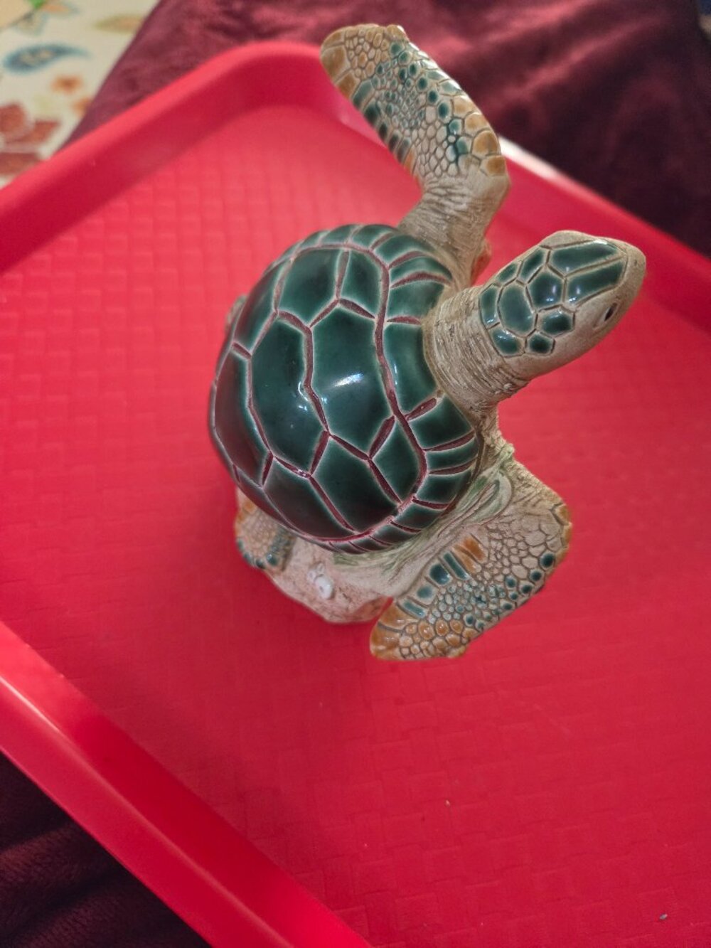 decorative turtle figurine with a deep green shell and oranges and red